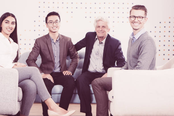 istock Four Smiling Diverse Business Partners in Lounge 943069898