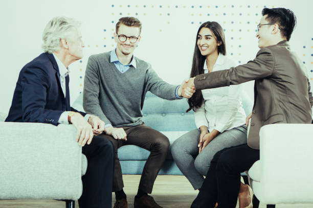 istock Smiling Business Partners Shaking Hands at Meeting 943069944