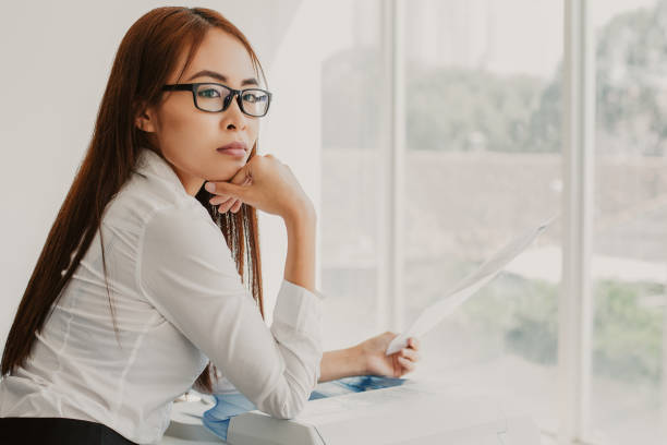 istock Pensive Female Secretary with Document at Window 943069960