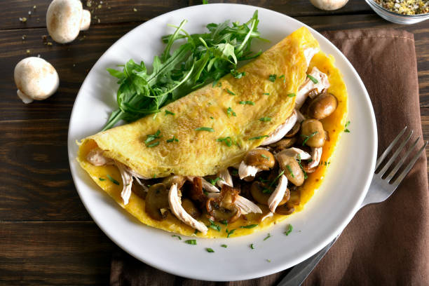 istock Omelette with mushrooms, chicken meat, greens 943070230