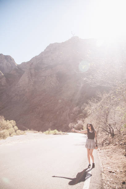 istock Young woman hitchhiking in Spain 943070526