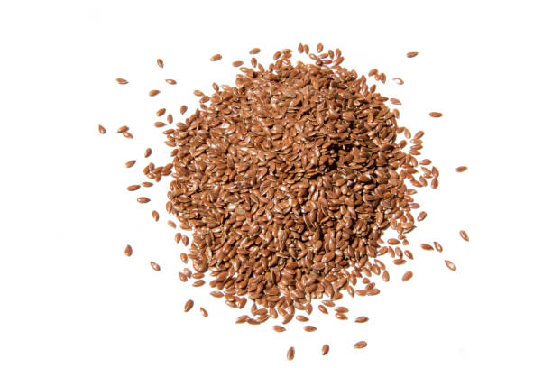 istock pile, heap of linseeds isolated on white background 943070870