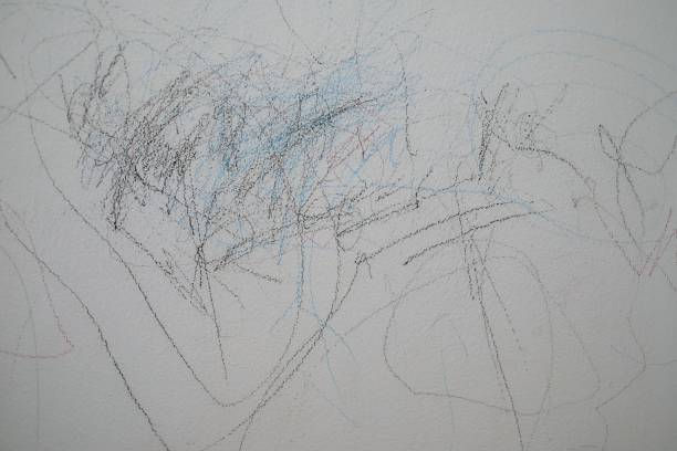 istock kid using color pencil written on concrete wall of the house 943074268