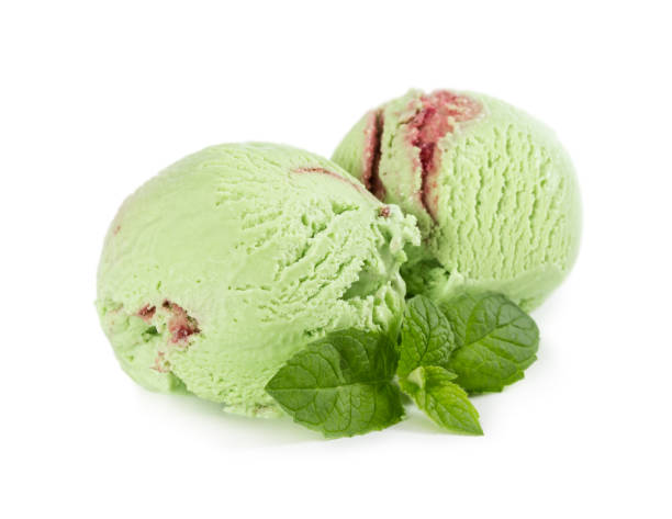 istock Two balls of mint raspberry ice cream with fresh mint isolated on white 943080602