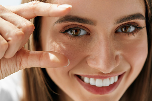 Healthy Eyevision. Beautiful Happy Woman With Focus On Her Eyes. Closeup Of Smiling Girl With Cheerful Look, Natural Makeup And Smooth Skin. Ophthalmology And Eyecare. High Resolution