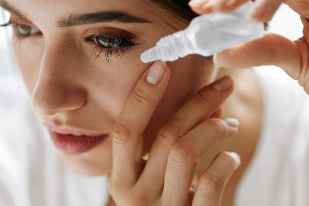 istock Beautiful Young Woman Applying Eyedrops In Eyes. Visual Concept 943082442