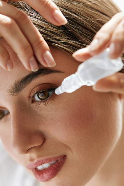 istock Beautiful Young Woman Applying Eyedrops In Eyes. Visual Concept 943082578