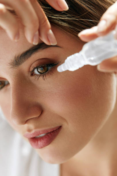 istock Beautiful Young Woman Applying Eyedrops In Eyes. Visual Concept 943082628