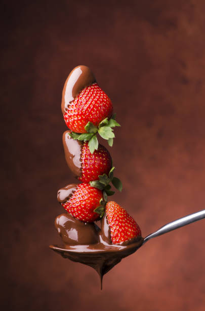 strawberries covered with melted chocolate delicious dessert of strawberries covered with hot dark chocolate ready to be tasted molten photos stock pictures, royalty-free photos & images