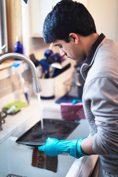 istock Young man doing his chores and washing the dishes 943089506