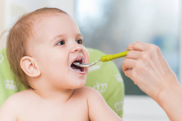 istock Mothers feeding the baby with cottage cheese 943091706