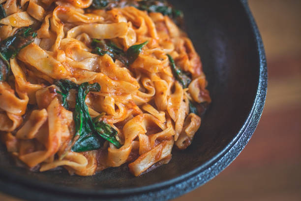istock Vegan pasta with tomato and spinach sauce 943100654