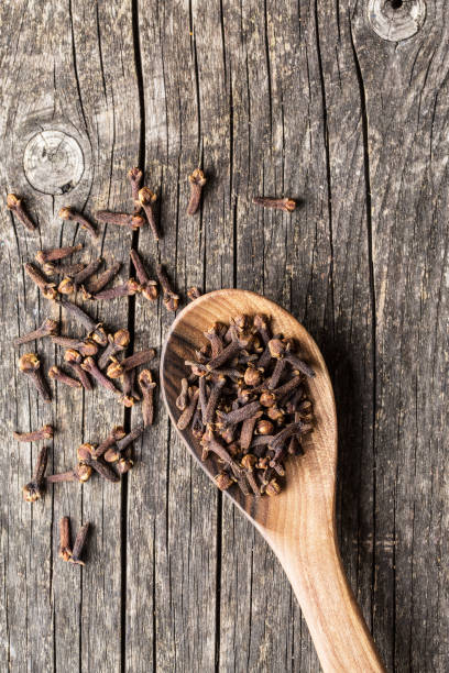 The clove spice in wooden spoon. Top view.