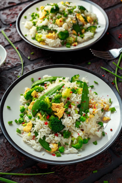 istock Fried rice with vegetables, broccoli, peas and eggs in a plate. healthy food 943101404