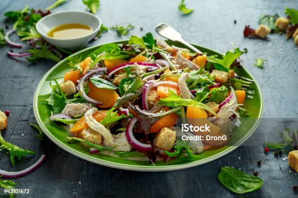 Fresh Salad With Chicken Breast Peach Red Onion Croutons And Vegetables In A Green Plate Healthy Food Stock Photo - Download Image Now