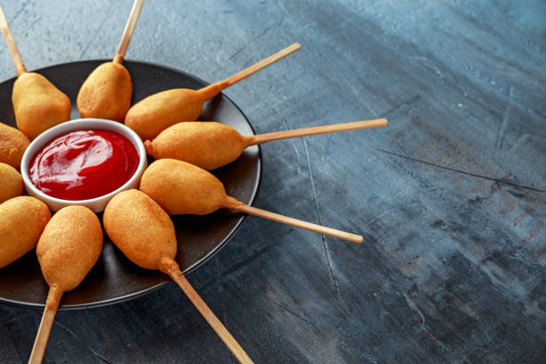 istock Mini Corn Dogs on black plate with ketchup 943110018