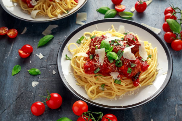 istock Spaghetti pasta meatballs with tomato sauce, basil, herbs parmesan cheese on dark background 943110228