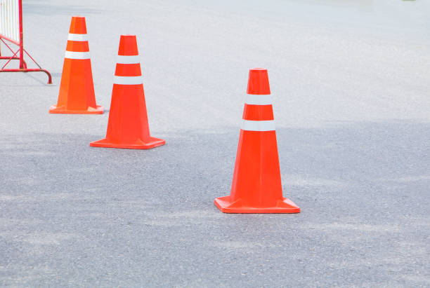istock Traffic cone row old orange and swath white stripes on the road with copy space 943111122
