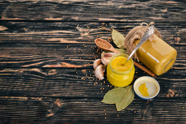 istock Mustard Sauce. Spices On a black wooden background. Top view. Copy space for your text. 943113300