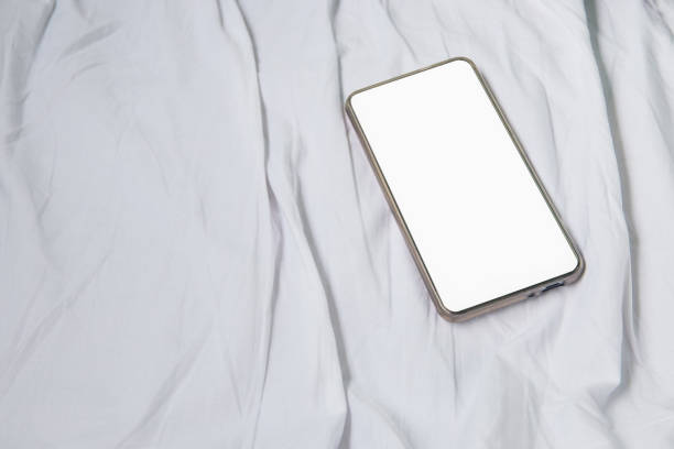 istock mobile phone on white bed in Interior train with copy space add text 943114362