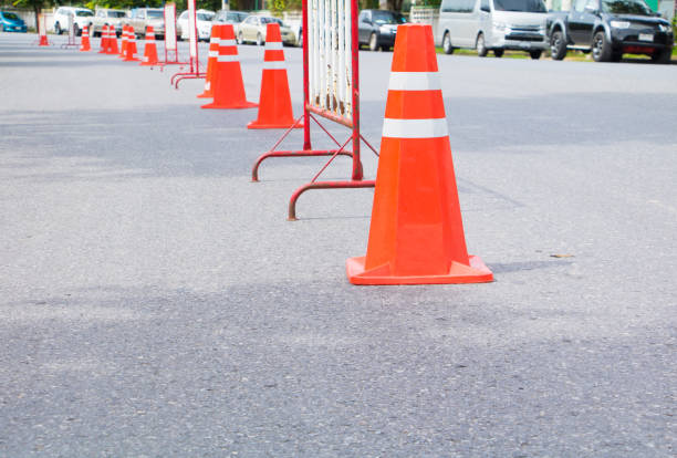 istock Traffic cone row old orange and swath white stripes on the road with copy space 943114458