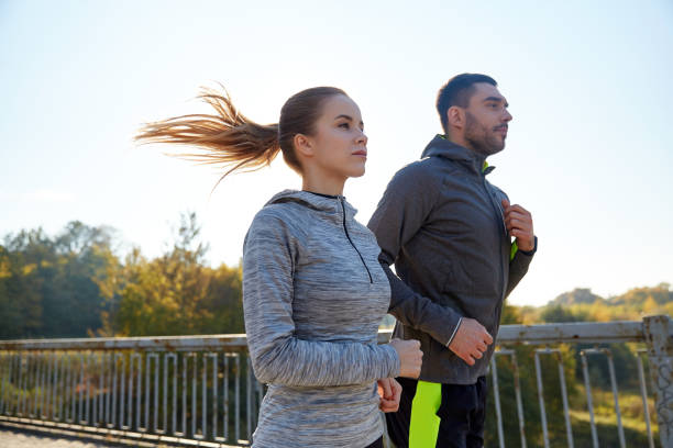 istock happy couple running outdoors 943115094