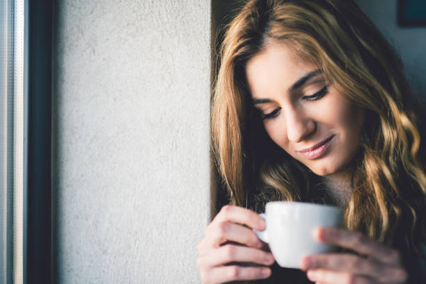 istock Girl holding a cup of coffee 943117696