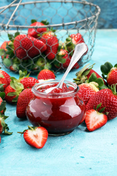 istock strawberry jam with fresh strawberries. marmalade on spoon and jar 943118304