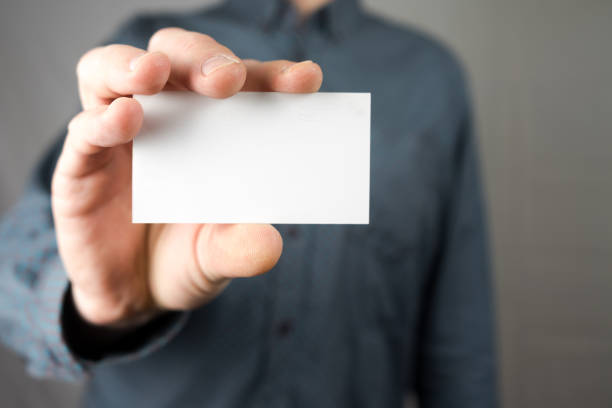 istock Businessman holding a business card. Mock up. Copy space. 943123256