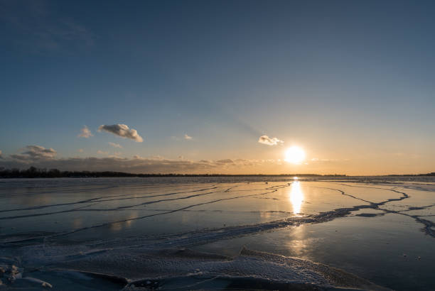 istock Sunset over a frozen lake 943126612
