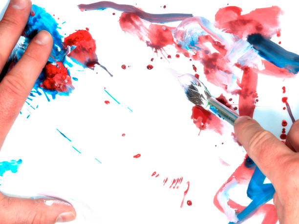 istock drawing paint on white paper, brush and hands. Concept drawing 943126796