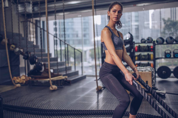 istock Woman training with battle ropes 943133776