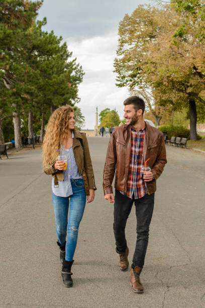 Young couple walking in the city park stock photo