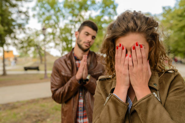 Man speaking to his girlfriend while she is crying stock photo