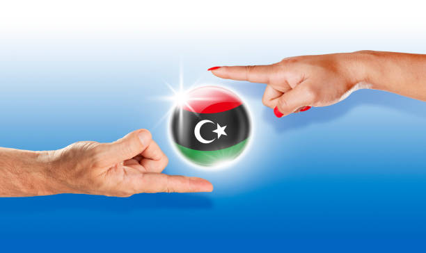 人間の手で浮間リビア ボタン リビア国旗 - libya flag libyan flag three dimensional shape ストックフォトと画像