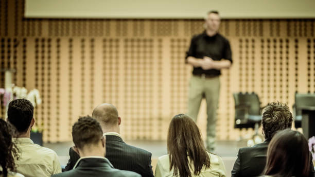 istock Audience listening to lecturer on stage 943163120