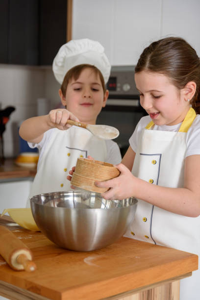 istock Boy and girl baking together in the home kitchen 943175756