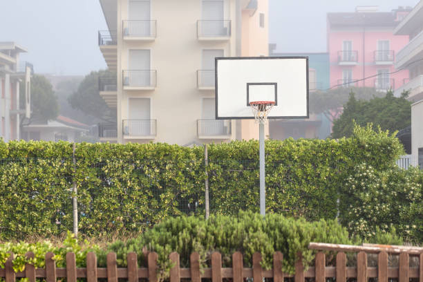 istock Basketball structure in an outdoor playground surrounded by trees in a park 943182024