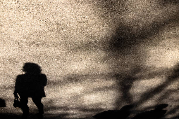 istock Silhouette shadow of a young woman walking 943192292