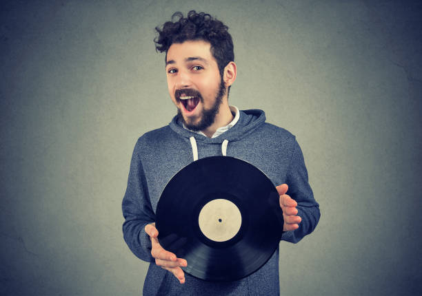istock excited hipster man with vinyl record looking at camera 943194856