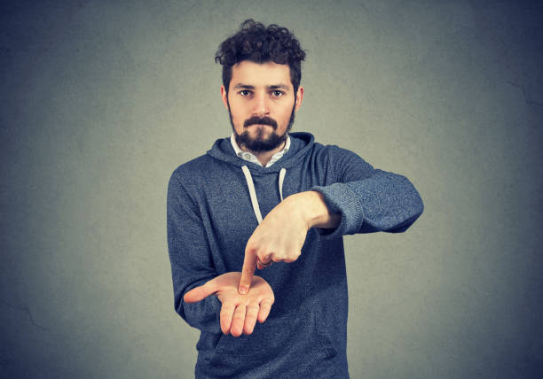 istock Young serious hipster man asking for more money 943194870