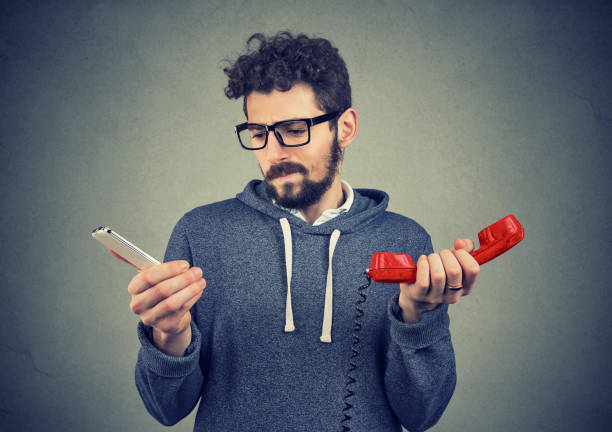 Confused man with old and new phones