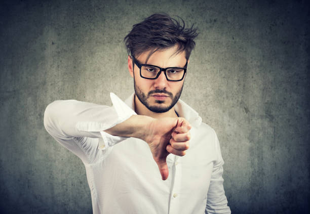 istock Upset man showing thumb up 943194994