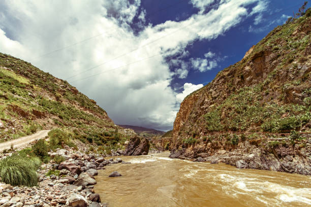 Rapids of the Colca River with suspension bridge in the background