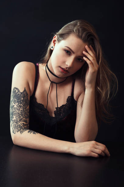 istock Young Woman With Tattoo Sitting At Table 943204208