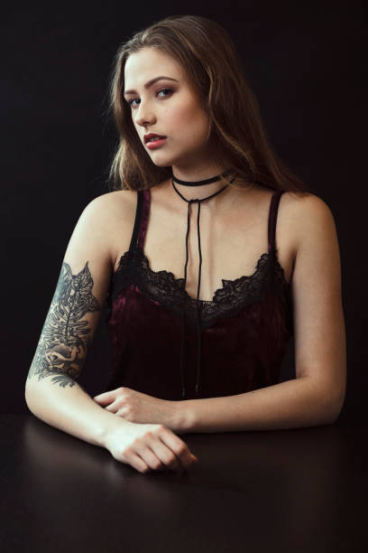 istock Young Woman With Tattoo Sitting At Table 943204212