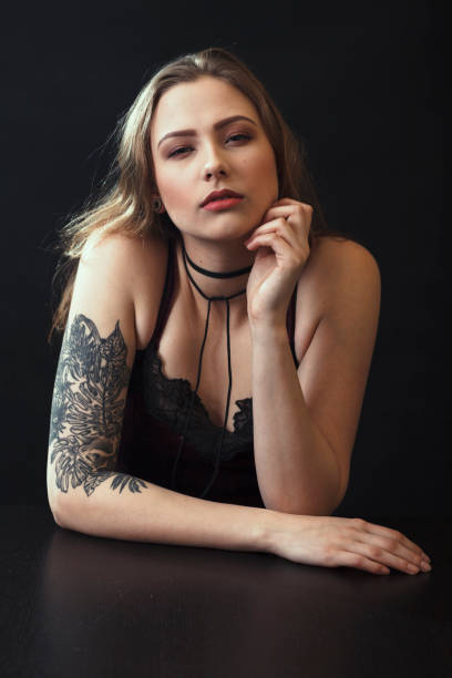 istock Young Woman With Tattoo Sitting At Table 943204216