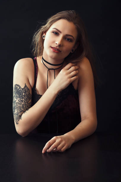 istock Young Woman With Tattoo Sitting At Table 943204236