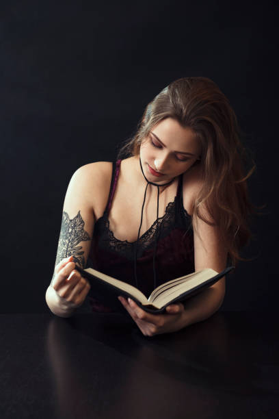 istock Young Woman Reading Book At Table 943204254