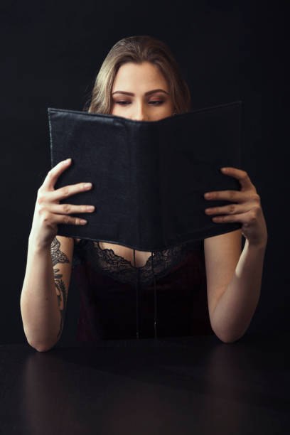 istock Young Woman Reading Book At Table 943204256